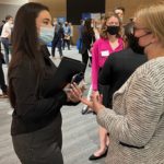 Student talks with professional at recruiting reception