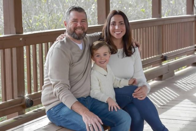 Brian and Jaime Reynolds on the porch with their son 