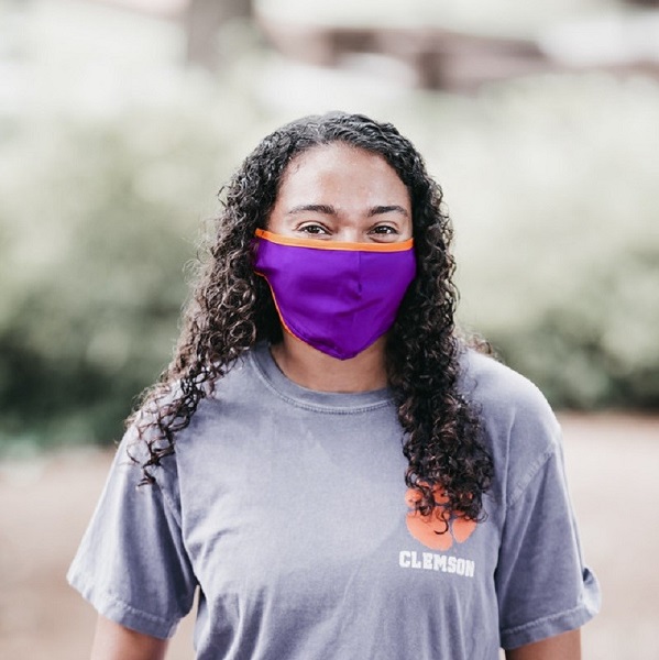 Clemson student wearing purple mask on campus