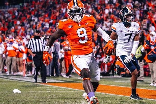 Clemson players runs into endzone during night game in Death Valley