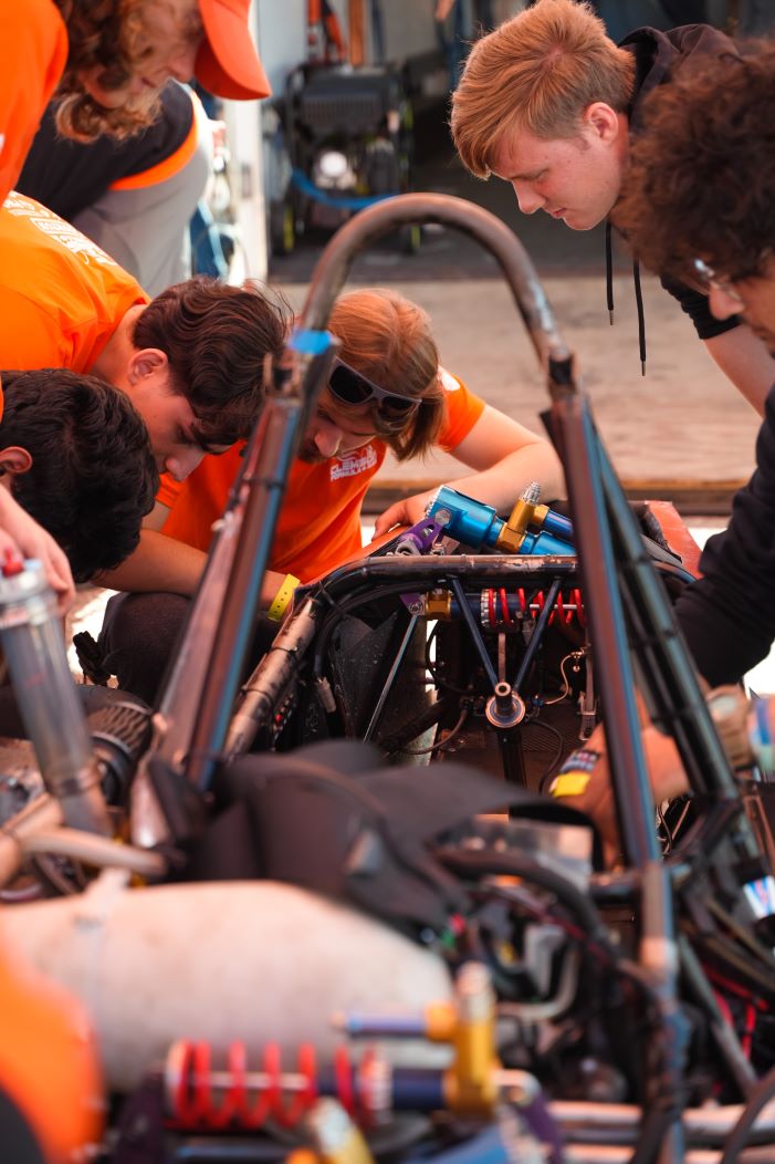 CUFSAE team members working on Tiger 24 before the competition