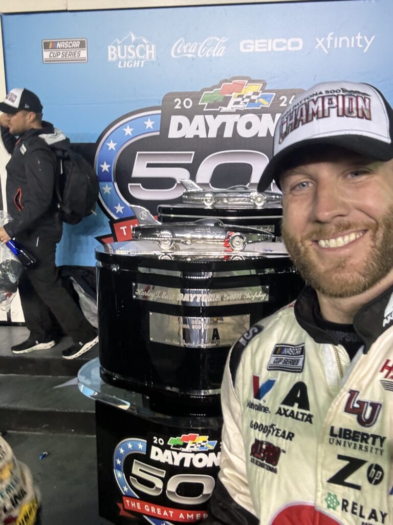 Landon Walker posing next to the Daytona 500 Harley J. Earle trophy