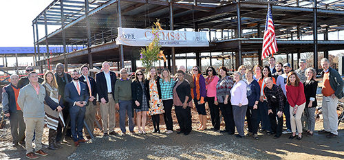 Group photo of staff and faculty at building site