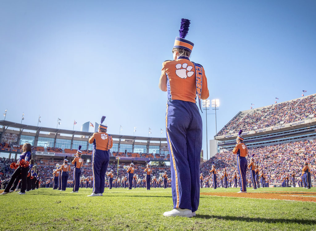 Tiger Band flutist stands on football field