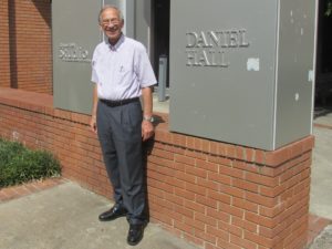 Dr. Beyerlein standing in front of Daniel Hall pillars