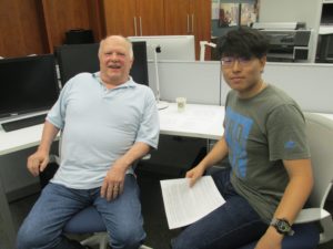 Professor and student sitting in chairs