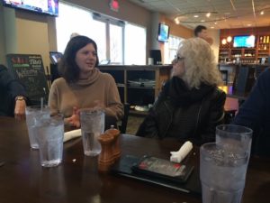 Younger female and older female talking