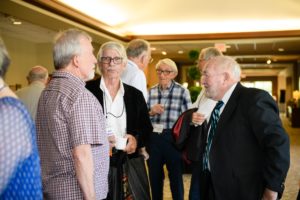 Several older gentlemen standing and talking