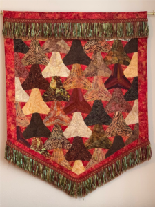 warm colored fabric art hanging
