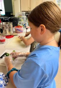 4-Her cutting up peppers
