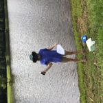 Haley in a mask standing near a pond