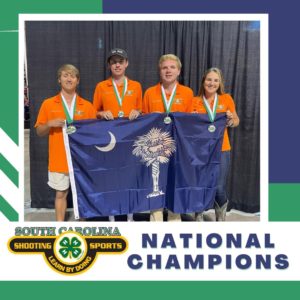 Four teenagers holding a SC flag.