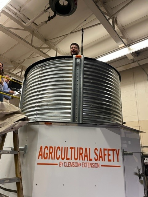 A large metal bin with a person in it.
