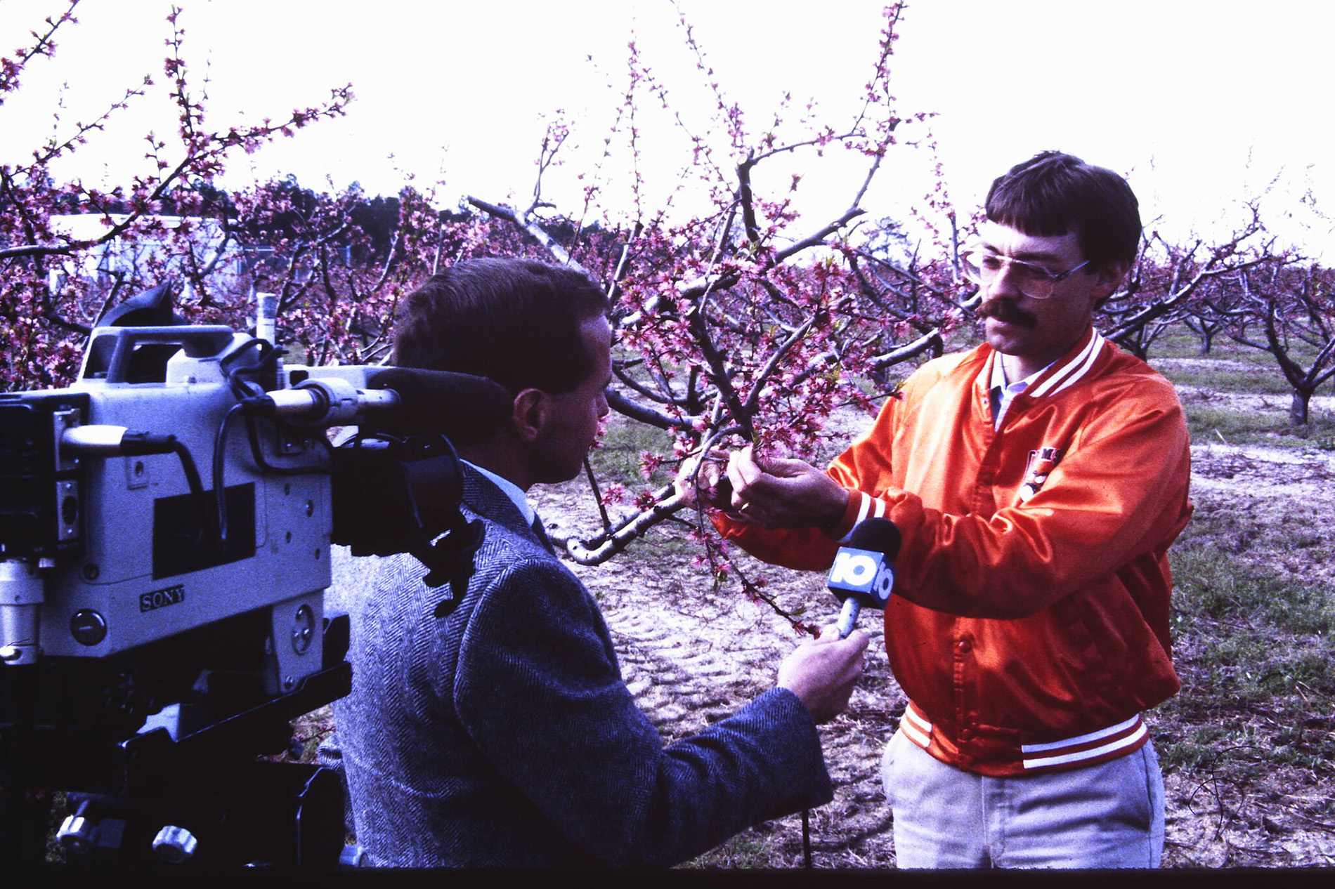 A man talking to a reporter with a camera.