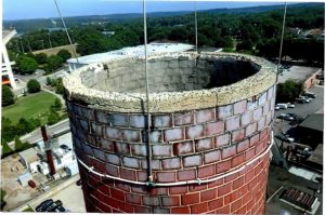 A photo of the condition of the South chimney's concrete cap and upper elevations. 