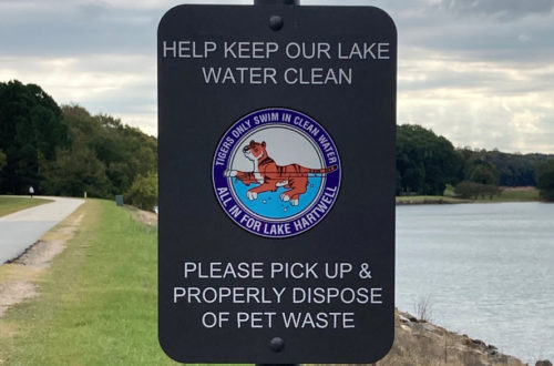 Photo of sign encouraging pet owners to pick up pet waste.