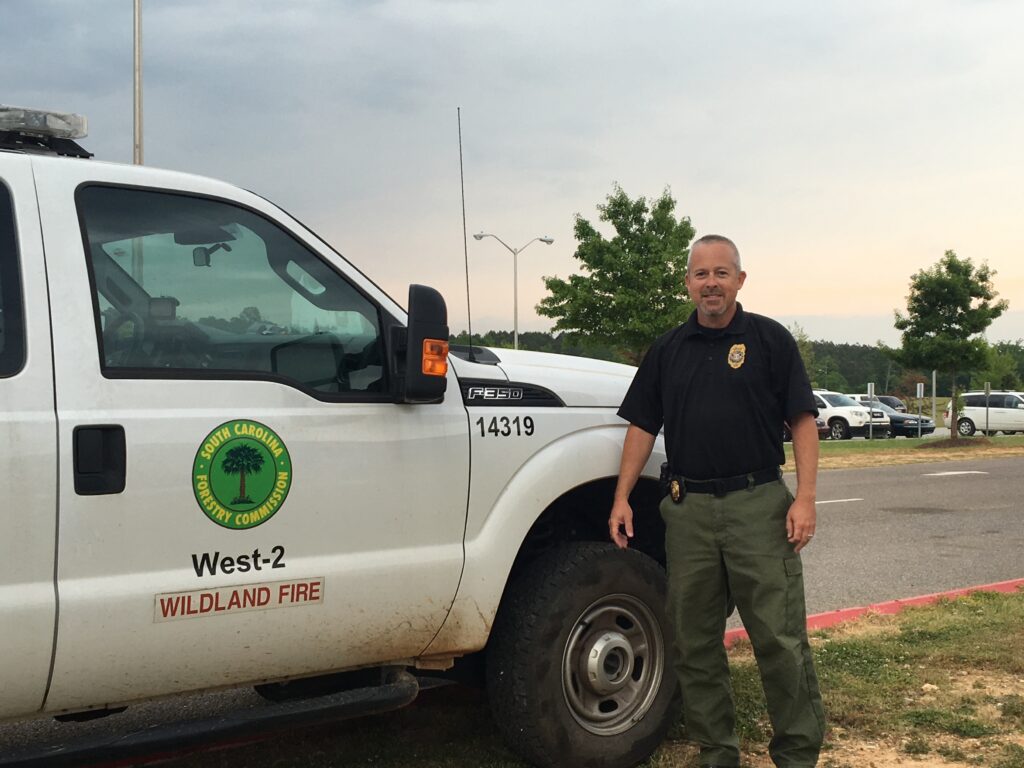 A man standing next to a truck.