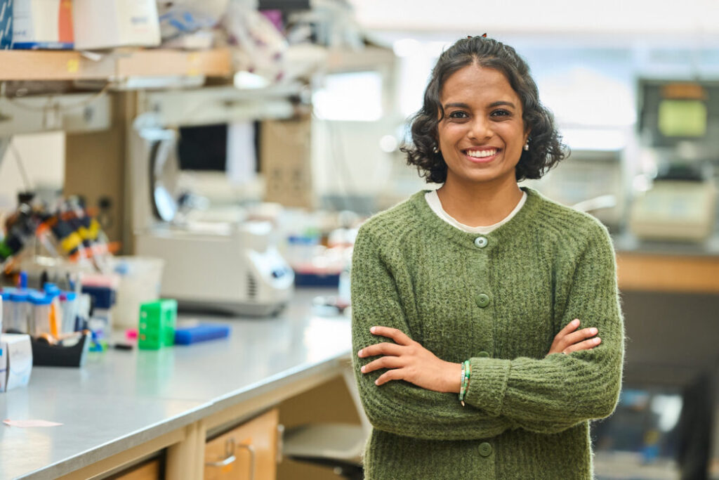 Girl in lab in green sweater.