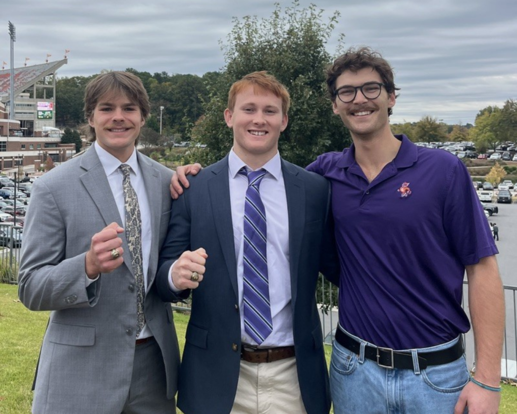 three men posing together for a photo.