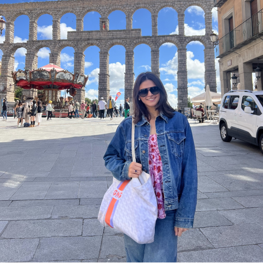 Woman traveling in Spain with sunglasses and denim jacket on.