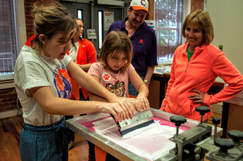 Printing pennants at ClemsonGC Homecoming 2018 in Godfrey Hall.