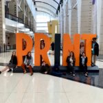 ClemsonGC students pose with the PRINT sign in McCormick Place.