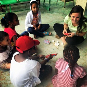 Photo of Language and International Health student XX works with children in a service learning project in Santiago, Dominican Republic.