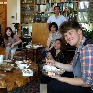 Photo of William Edwards enjoyings dinner with a Japanese family during his home stay. 