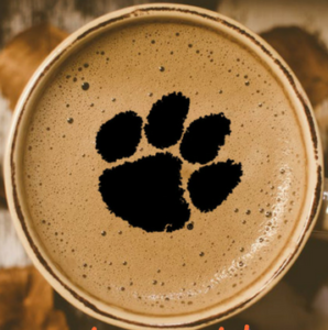 A round coffee mug with the paw logo in the foam.
