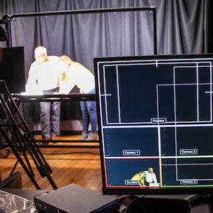 Two persons working in the Lightboard studio.