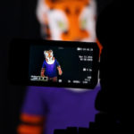 Image of the Clemson Tiger mascot through a video camera viewfinder. The Tiger mascot can also be seen in the background, out of focus.