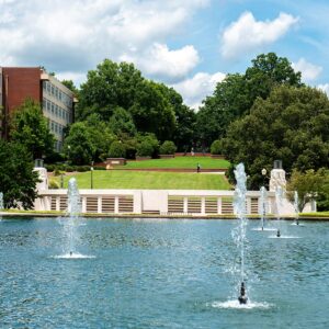 Fountain in front of Cooper Library on Clemson University's campus on a sunny day, blue sky