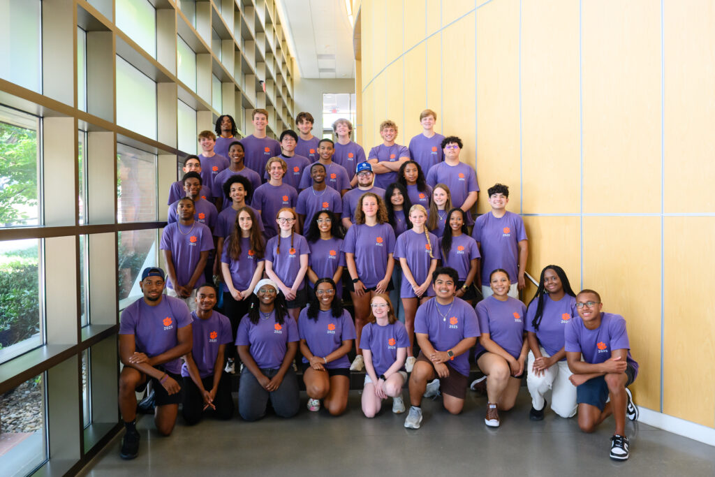 A group of Summer Bridge students in the PEER WISE Experience (PWE) smile and pose together on the steps of Freeman Hall. During the four-week program, students build strong connections with their cohort, faculty, and PEER WISE staff.