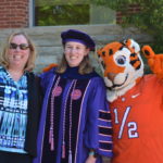 Picture of Haley Griffiths, Ph.D., posing with the Clemson tiger and her mother.
