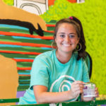 Clemson PRTM alumni Lacey Hennessey painting the mural in Clemson’s new Tipsy Taco restaurant.