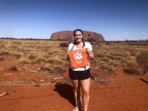 Picture of Nicole Entrup standing in front of Uluru in Australia. 