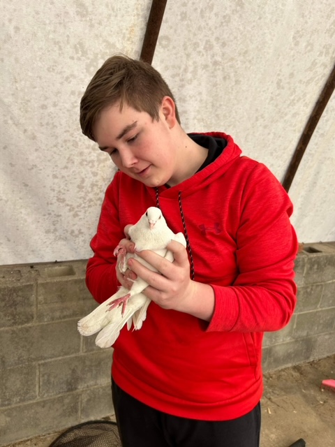 Student holding a white bird