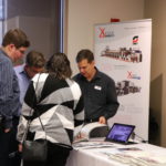 Attendees network with vendors at the OMET open house
