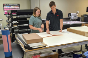Scott Rickard of Dupont works with one of the Sonoco Institute interns during a print trial