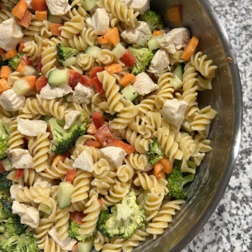 Chicken and vegetable pasta salad - protein pasta is combined with a variety of vegtables such as chopped carrots, peppers, broccoli, and cucumber as well as boiled chicken and is then tossed in a light dressing which includes light mayonnaise, red wine vinegar and italian seasoning.