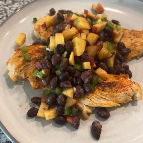 Sauteed chicken breast is topped with a simple, peach and black bean salasa