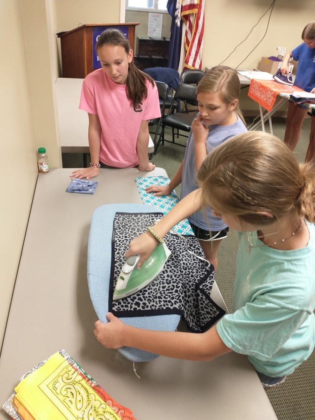 Newberry County 4-H members learning to iron.