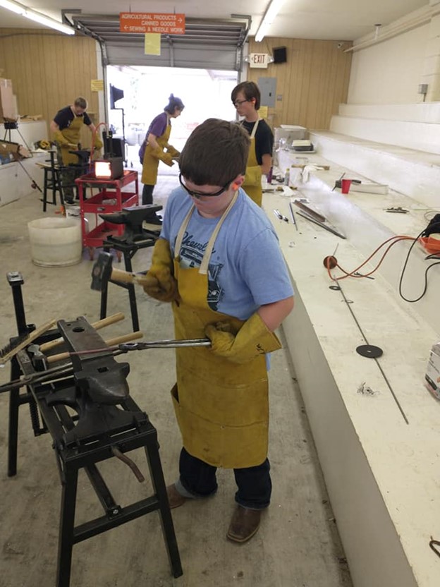 Newberry County 4-H members learning to forge metal. 