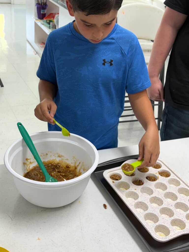 Young 4-Her making pecan pie muffins