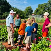 4-Hers in a garden with Andy