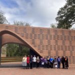 The cemetery team and Lemon Project team stand together in front of the Hearth Memorial at William & Mary in Virginia.